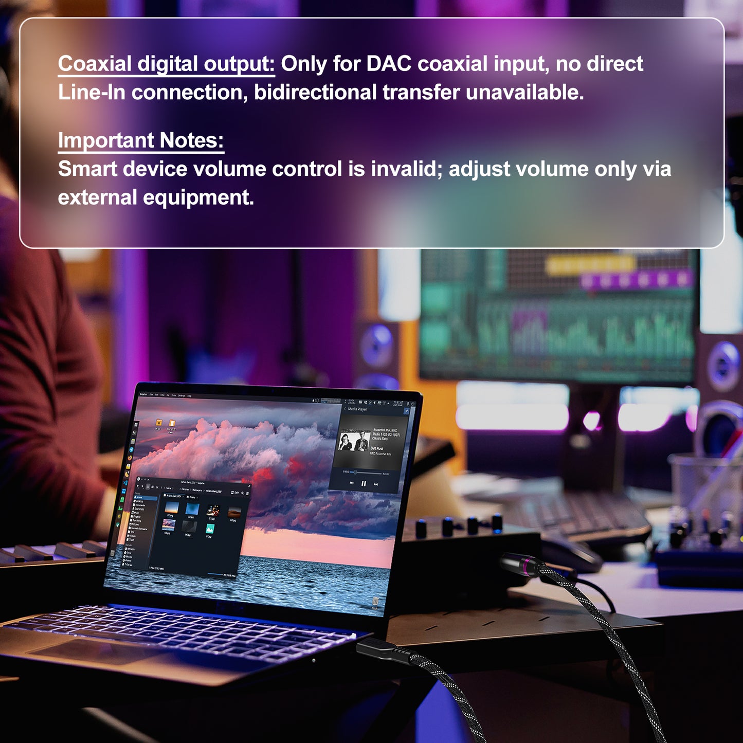 A laptop on a desk in a dimly lit studio or control room setup, with a semi-transparent text overlay explaining DAC coaxial input limitations and volume control instructions.